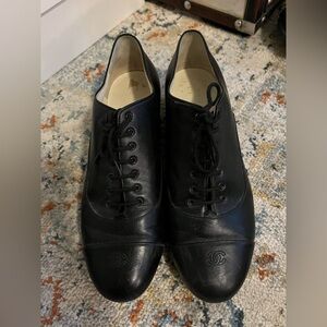 Chanel black laced up Oxford uniform.